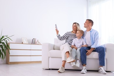 Photo of Family using remote to control air conditioner at home