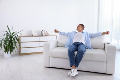 Photo of Young man relaxing on sofa at home