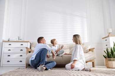 Photo of Family using remote to control air conditioner at home