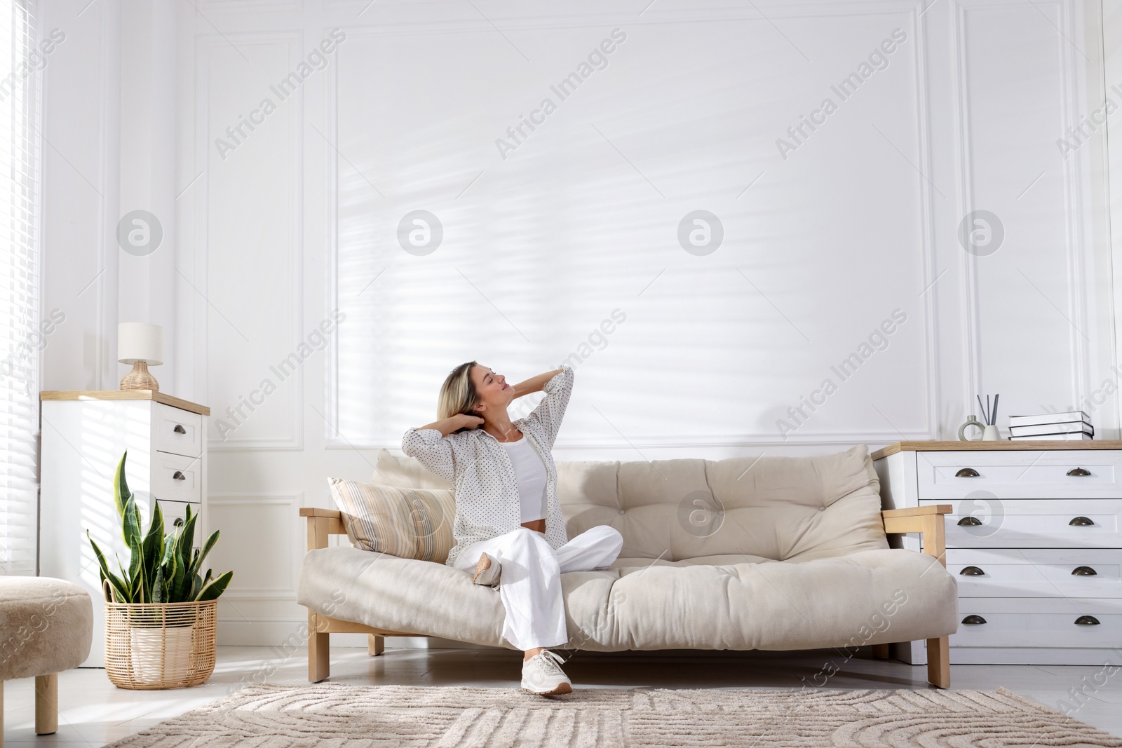 Beautiful woman relaxing on sofa at home Photo of Beautiful woman relaxing on sofa at home