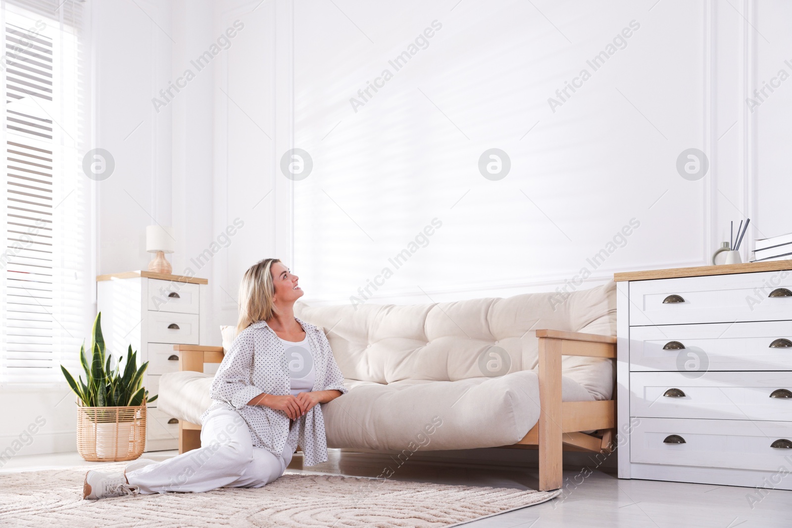 Beautiful smiling woman looking at something indoors Photo of Beautiful smiling woman looking at something indoors