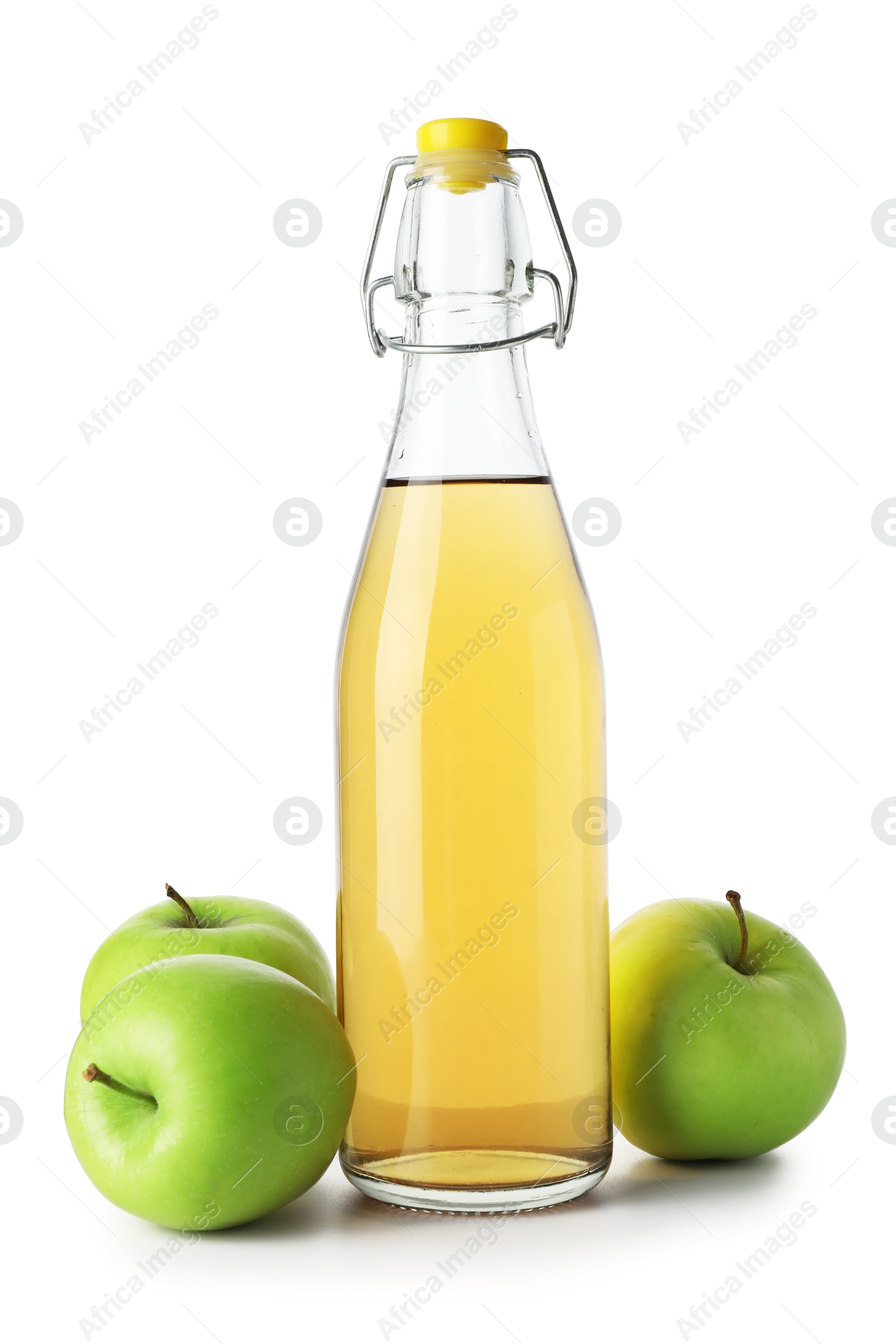 Delicious cider in glass bottle and apples isolated on white Photo of Delicious cider in glass bottle and apples isolated on white