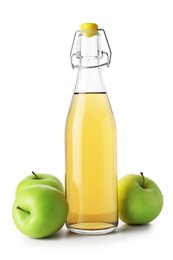 Photo of Delicious cider in glass bottle and apples isolated on white