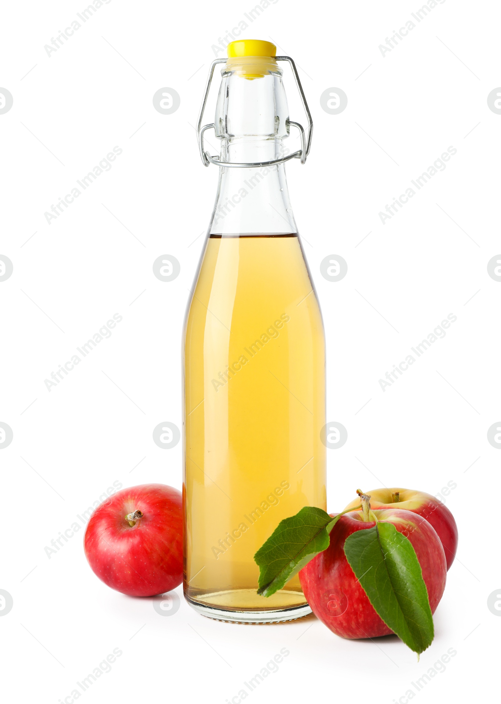 Photo of Delicious cider in glass bottle and apples isolated on white