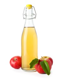 Photo of Delicious cider in glass bottle and apples isolated on white