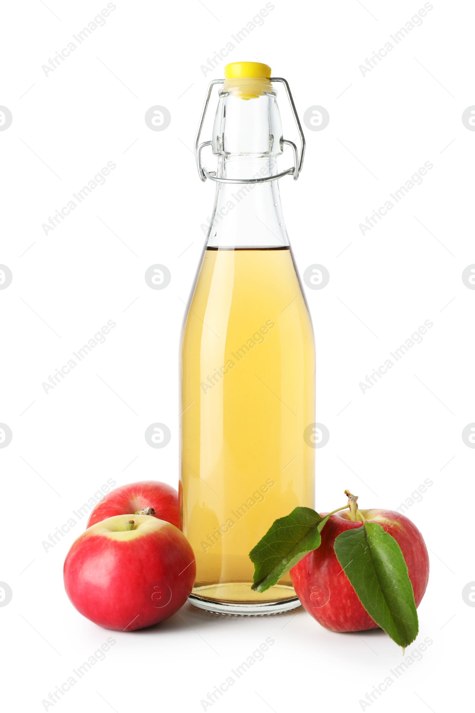 Delicious cider in glass bottle and apples isolated on white Photo of Delicious cider in glass bottle and apples isolated on white