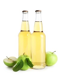 Photo of Delicious cider in glass bottles and apples isolated on white