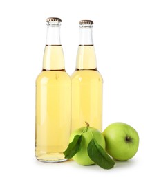 Photo of Delicious cider in glass bottles and apples isolated on white