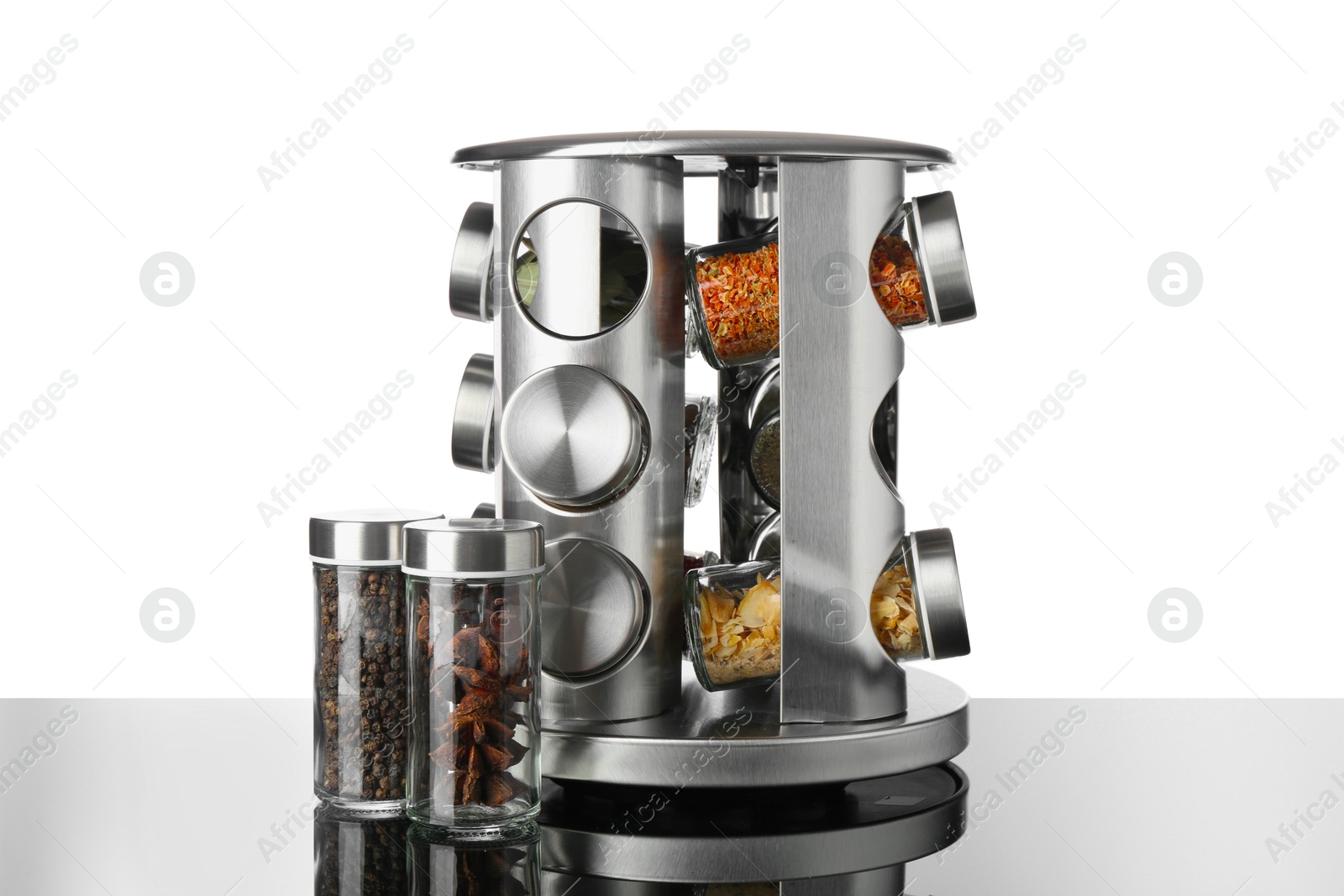 Photo of Set of spices in jars on table against white background