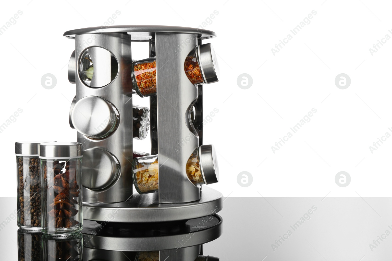 Photo of Set of spices in jars on table against white background