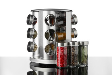 Photo of Set of spices in jars on table against white background