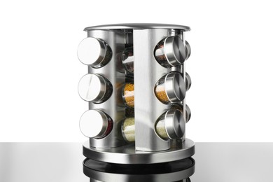 Photo of Set of spices in jars on table against white background