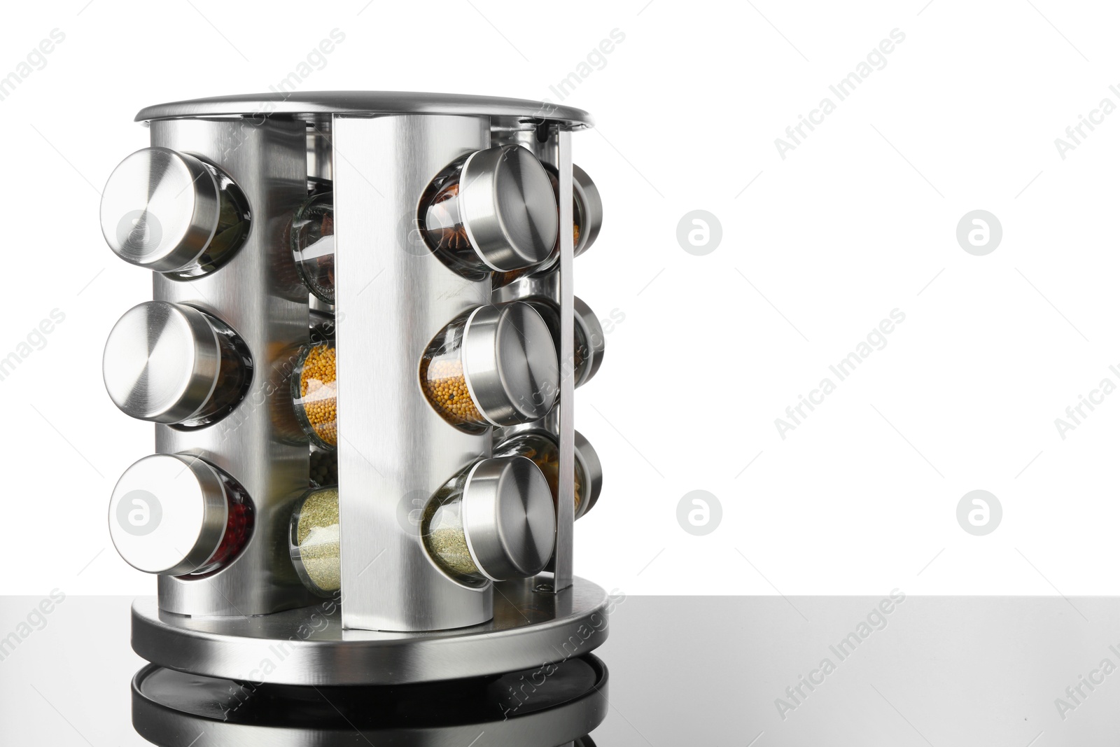 Photo of Set of spices in jars on table against white background