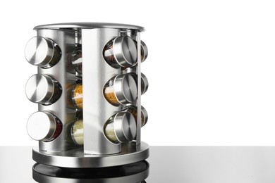 Photo of Set of spices in jars on table against white background