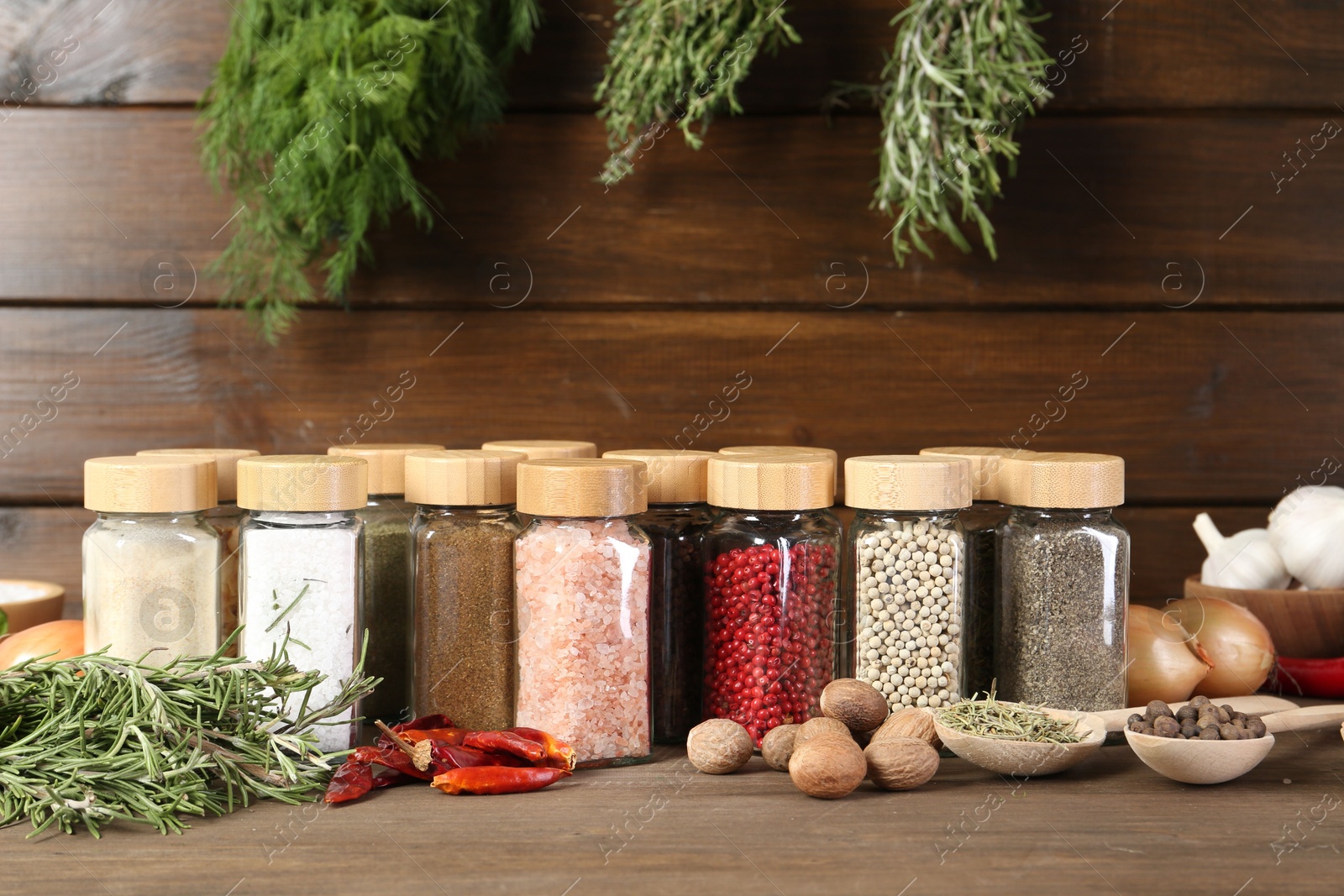 Photo of Different spices and jars on wooden table