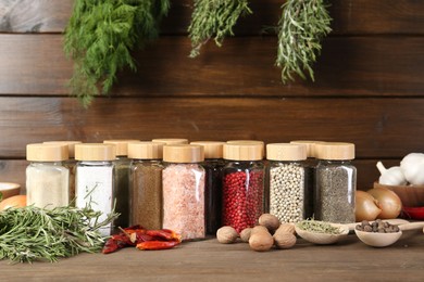 Photo of Different spices and jars on wooden table