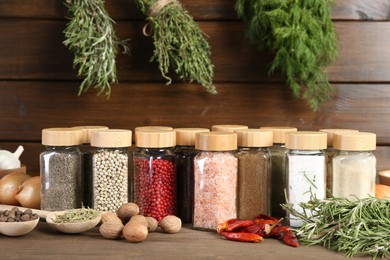 Photo of Different spices and jars on wooden table