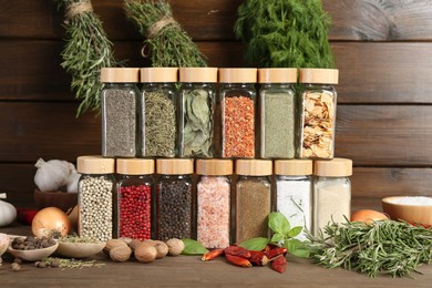 Photo of Different spices and jars on wooden table
