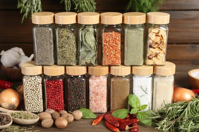Photo of Different spices and jars on wooden table