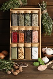 Photo of Different spices and jars on wooden table