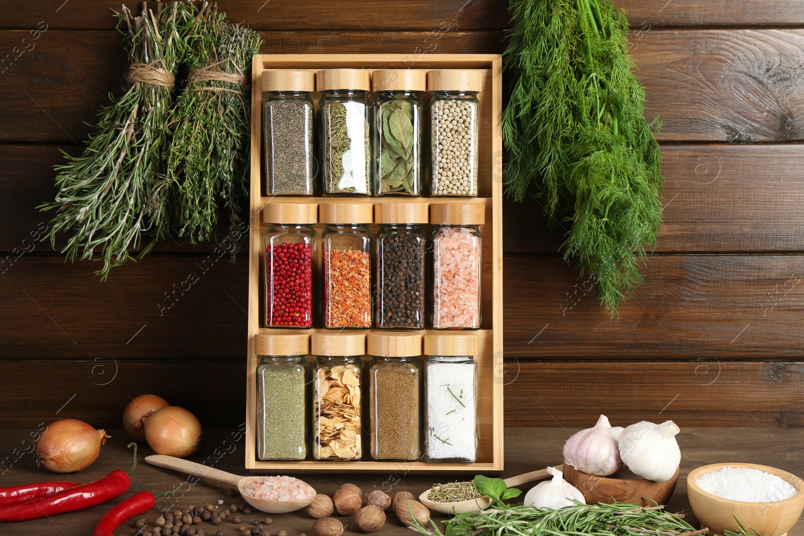 Photo of Different spices and jars on wooden table
