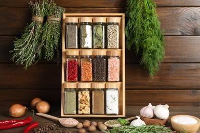 Photo of Different spices and jars on wooden table