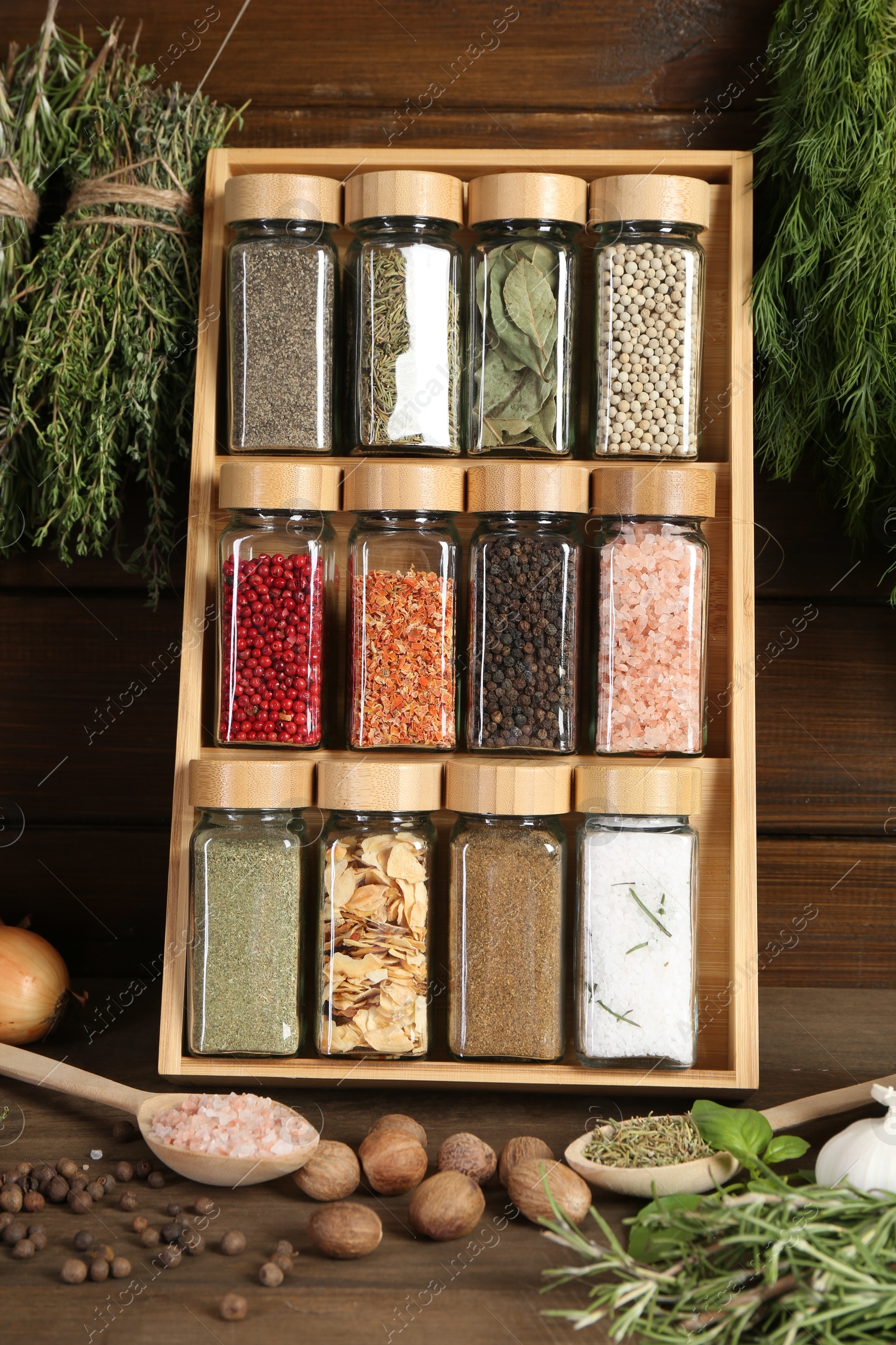 Photo of Different spices and jars on wooden table