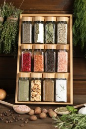 Photo of Different spices and jars on wooden table