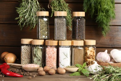 Photo of Different spices and jars on wooden table