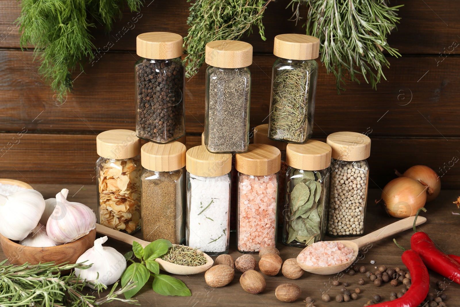 Photo of Different spices and jars on wooden table