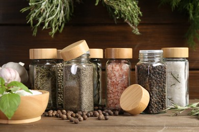 Photo of Different spices and jars on wooden table