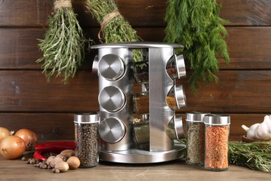 Photo of Different spices and jars on wooden table