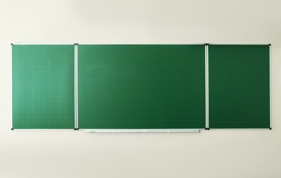 Photo of Green chalkboard on wall in classroom. Back to school