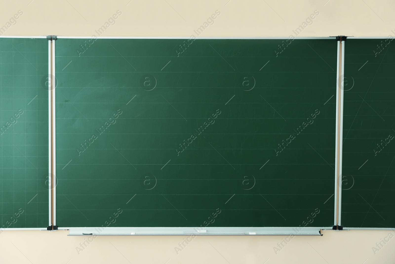 Photo of Green chalkboard on wall in classroom. Back to school
