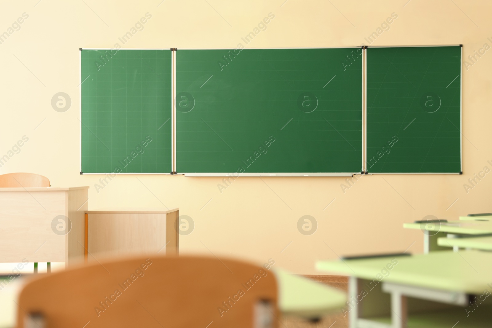 Photo of Green chalkboard on wall in classroom. Back to school