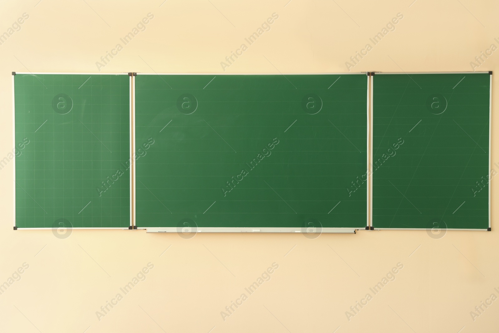Photo of Green chalkboard on wall in classroom. Back to school