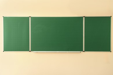 Photo of Green chalkboard on wall in classroom. Back to school