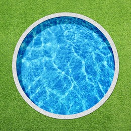 Image of Round swimming pool surrounded by green grass, top view