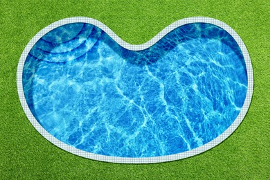 Image of Swimming pool surrounded by green grass, top view