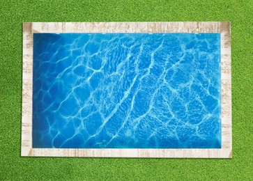 Image of Swimming pool surrounded by green grass, top view