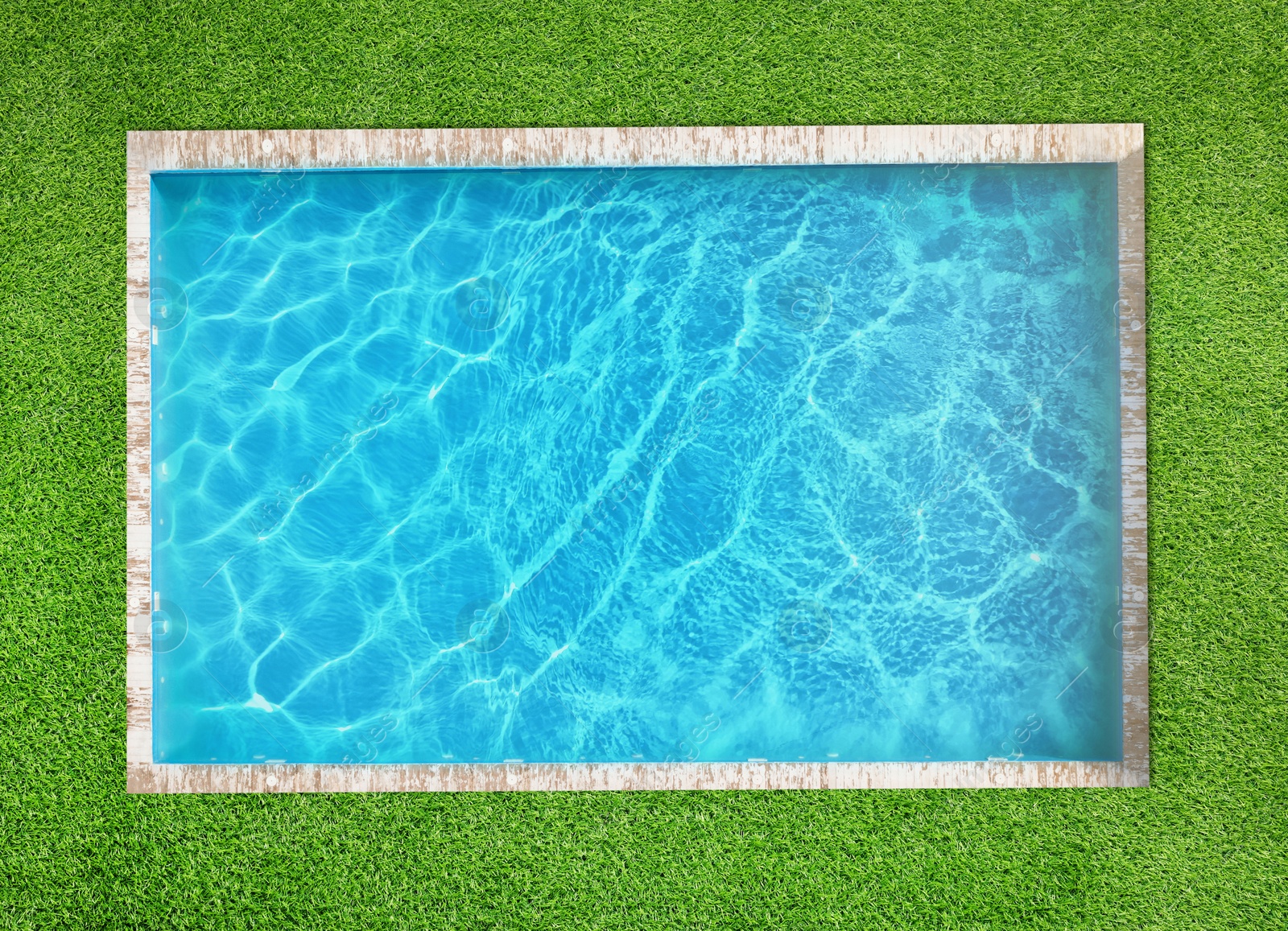 Swimming pool surrounded by green grass, top view Image of Swimming pool surrounded by green grass, top view