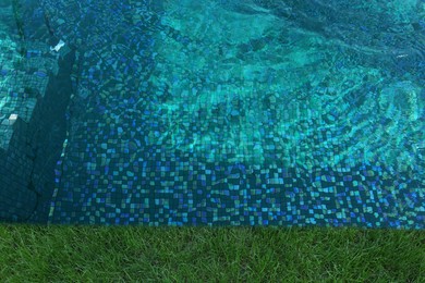 Image of Swimming pool surrounded by green grass, top view