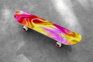 Image of Skateboard with colorful pattern on grey textured surface