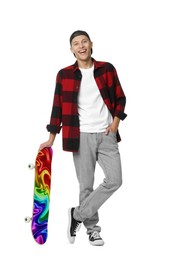 Image of Happy man holding skateboard with bright pattern on white background