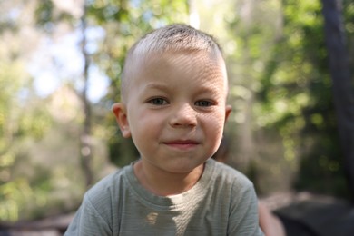 Photo of Portrait of cute little boy outdoors on sunny day
