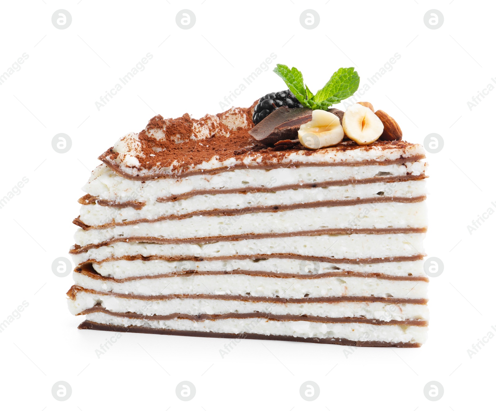 Photo of Piece of tasty crepe cake with cocoa powder, chocolate, nuts and blackberry isolated on white