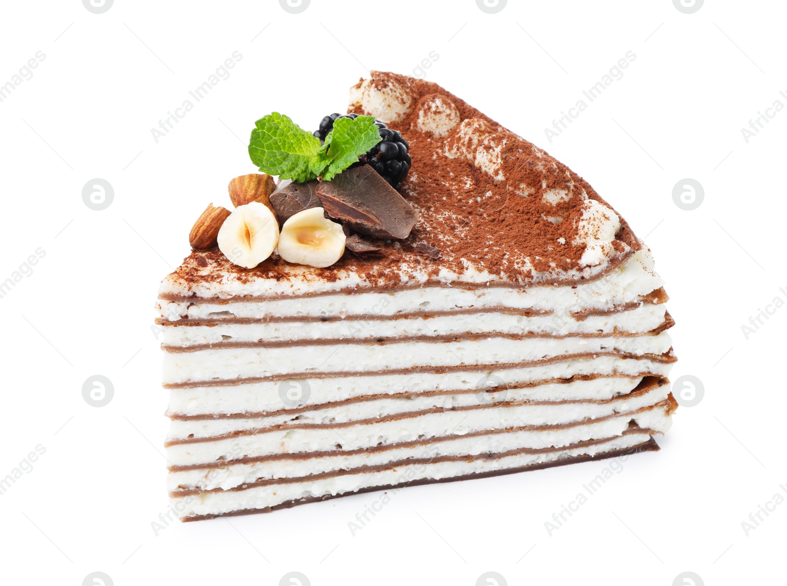 Photo of Piece of tasty crepe cake with cocoa powder, chocolate, nuts and blackberry isolated on white