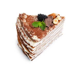 Photo of Piece of tasty crepe cake with cocoa powder, chocolate, nuts and blackberry isolated on white