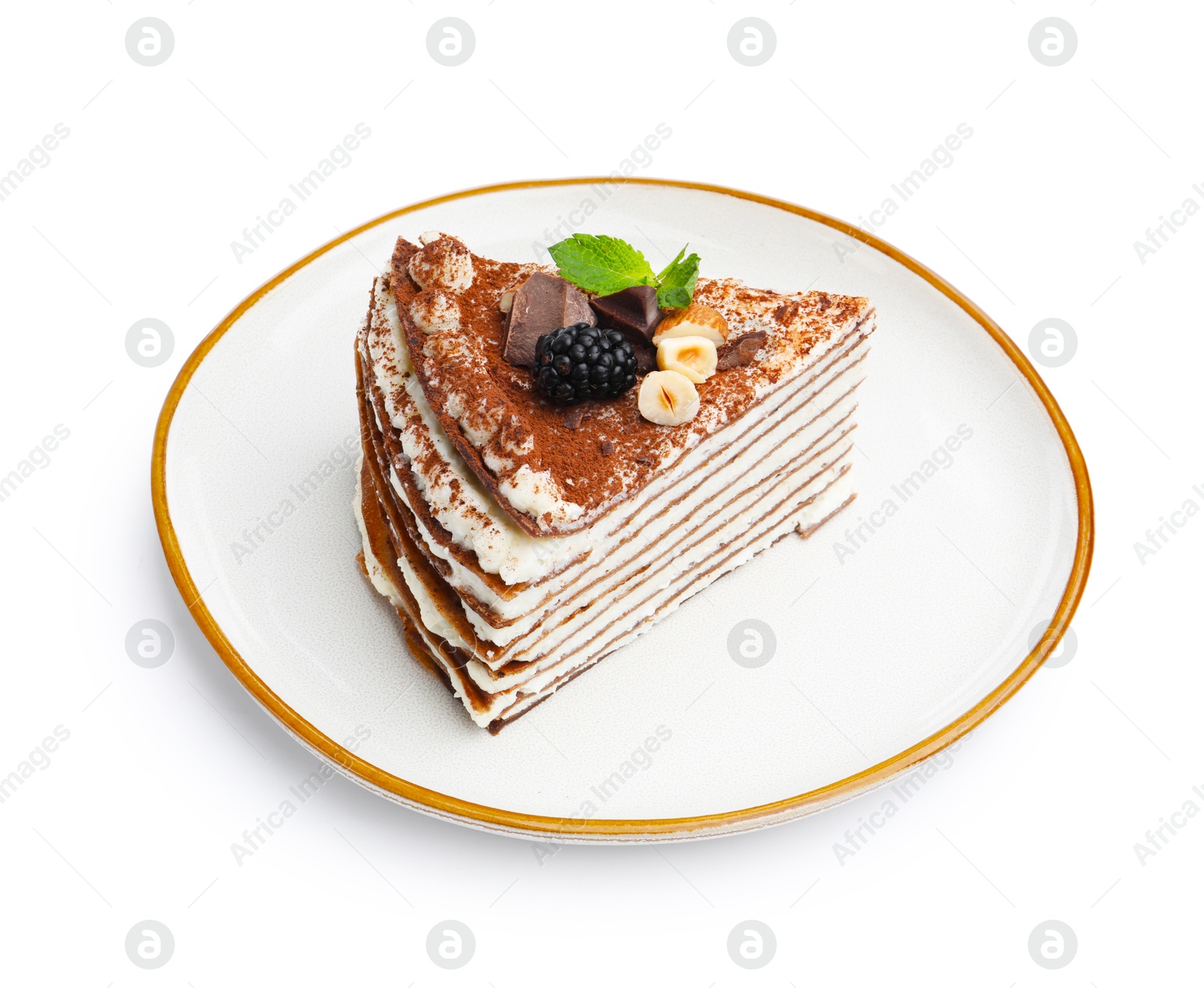 Photo of Piece of tasty crepe cake with cocoa powder, chocolate, nuts and blackberry isolated on white