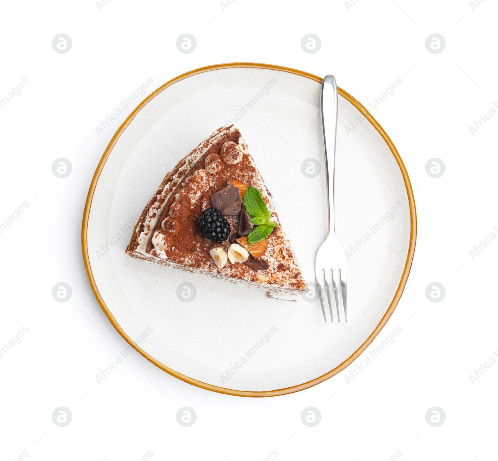Photo of Piece of tasty crepe cake with cocoa powder, chocolate, nuts and blackberry isolated on white, top view
